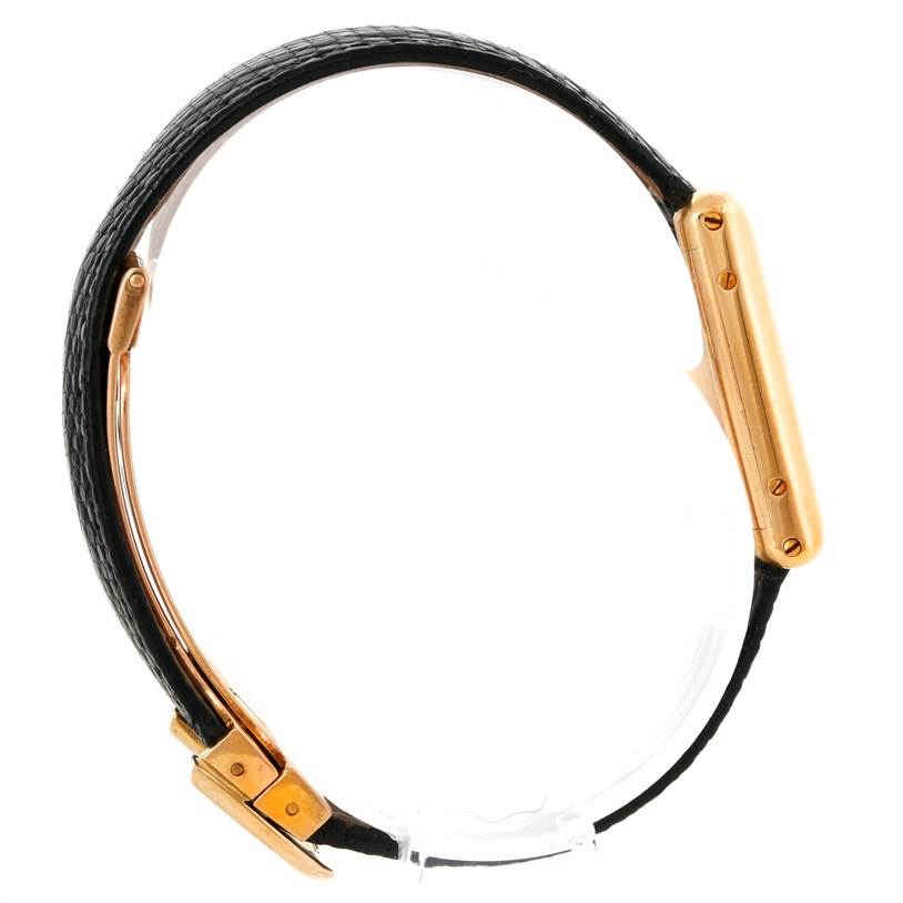 The image shows a side profile of a Tank Classic model by Cartier, highlighting its gold case and black leather strap.