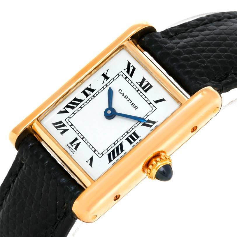 The image shows a Cartier Tank Classic Women's Yellow Gold White Dial Women's Yellow Gold White Dial watch at a slight angle, highlighting its rectangular face, Roman numerals, and black leather strap.
