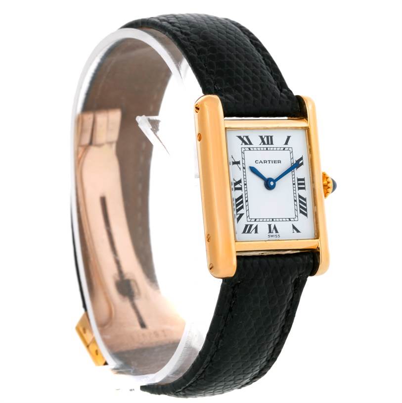 The Cartier Tank Classic Women's Yellow Gold White Dial Women's Yellow Gold White Dial watch is shown at a side angle, displaying its gold case, white dial with Roman numerals, and black leather strap.
