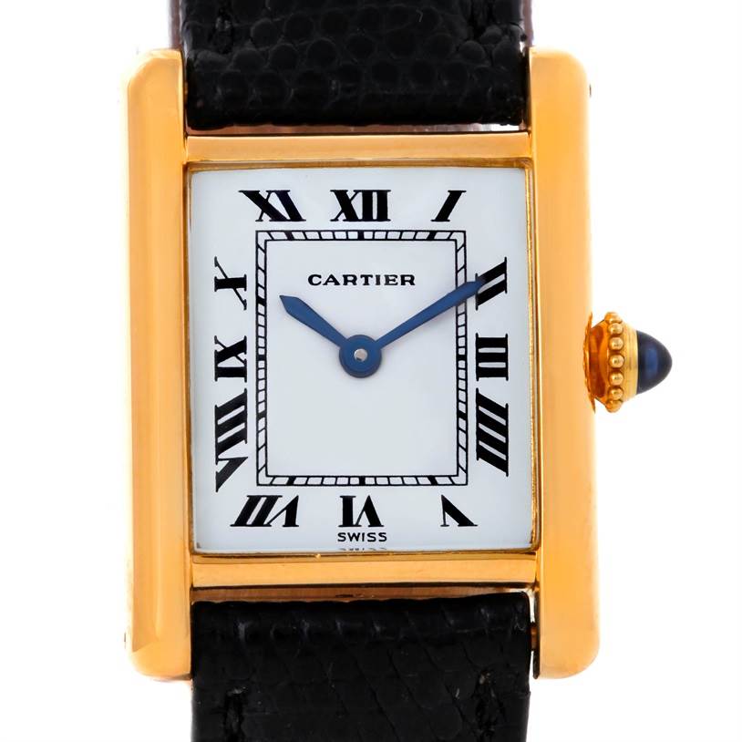 This is a close-up view of a Cartier Tank Classic Women's Yellow Gold White Dial Women's Yellow Gold White Dial watch, showing its rectangular dial, Roman numerals, and black leather strap.