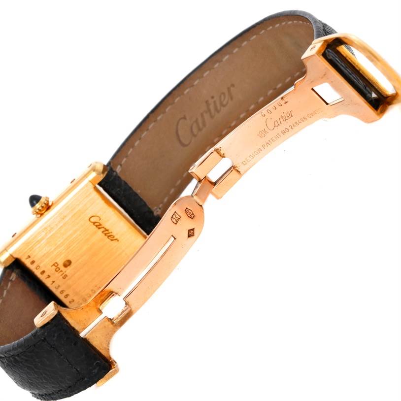 This image shows the back view of a Cartier Tank Classic Women's Yellow Gold White Dial Women's Yellow Gold White Dial watch, highlighting the clasp and inner side of the leather strap.