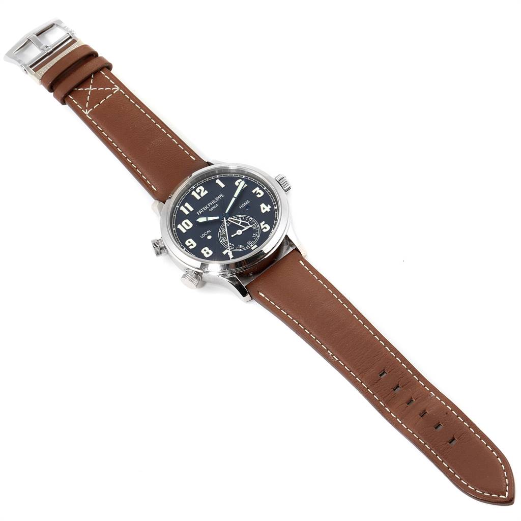 The image displays a Patek Philippe Calatrava 5524G Men's White Gold Blue Dial 5524G Men's White Gold Blue Dial watch, showcasing the face, bezel, crown, and brown leather strap from a top-down angle.