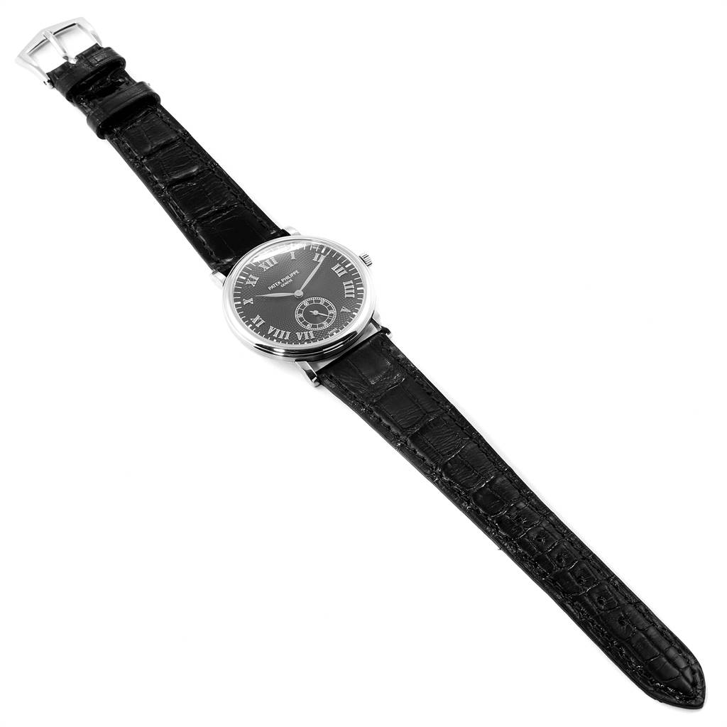 The image shows a full-view angle of the Patek Philippe Calatrava 5022 Men's White Gold Black Dial 5022 Men's White Gold Black Dial watch with a black leather strap and a black dial displaying Roman numerals.