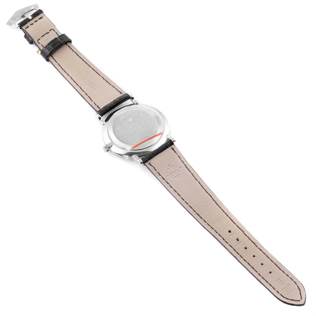 The image shows the back side of a Patek Philippe Calatrava 5022 Men's White Gold Black Dial 5022 Men's White Gold Black Dial watch, highlighting its leather strap and metal case back.