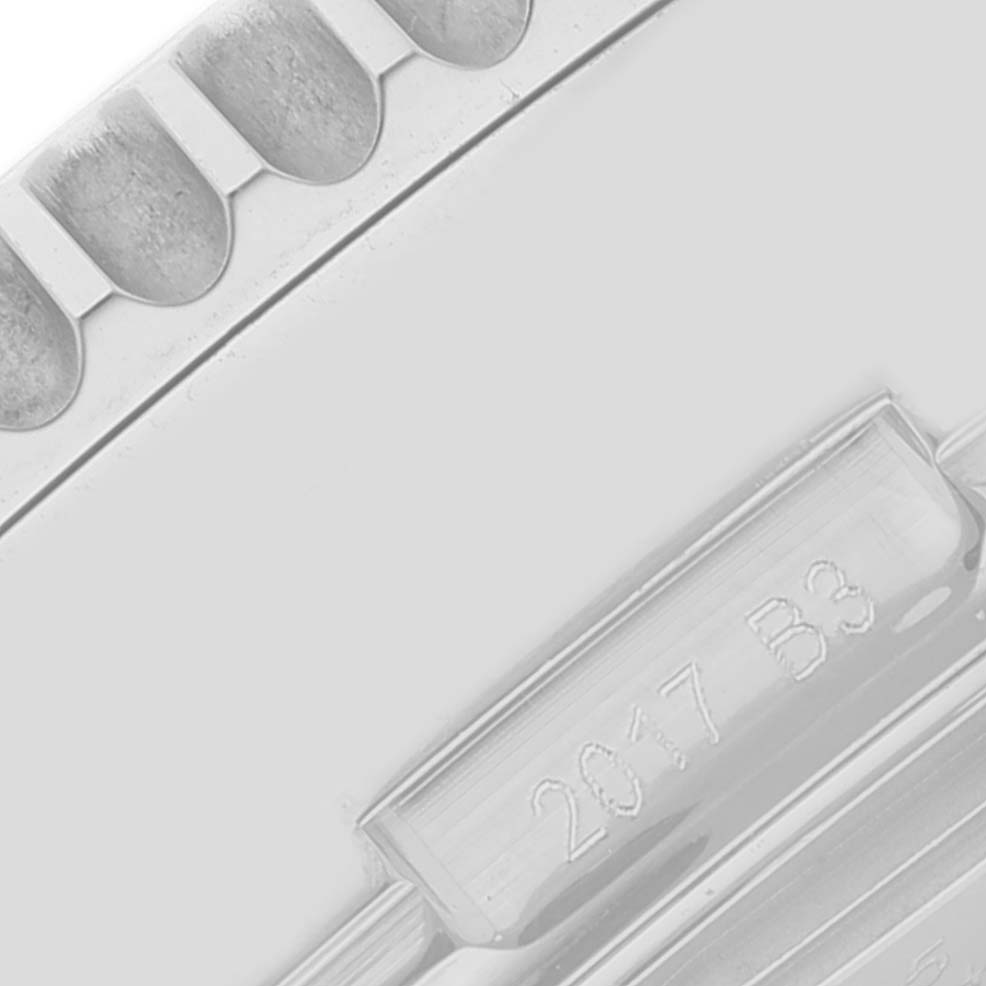 This image shows a close-up of the bezel and part of the case back with engravings on a Breitling Navitimer AB0310 Men's Stainless Steel Black Dial AB0310 Men's Stainless Steel Black Dial watch.