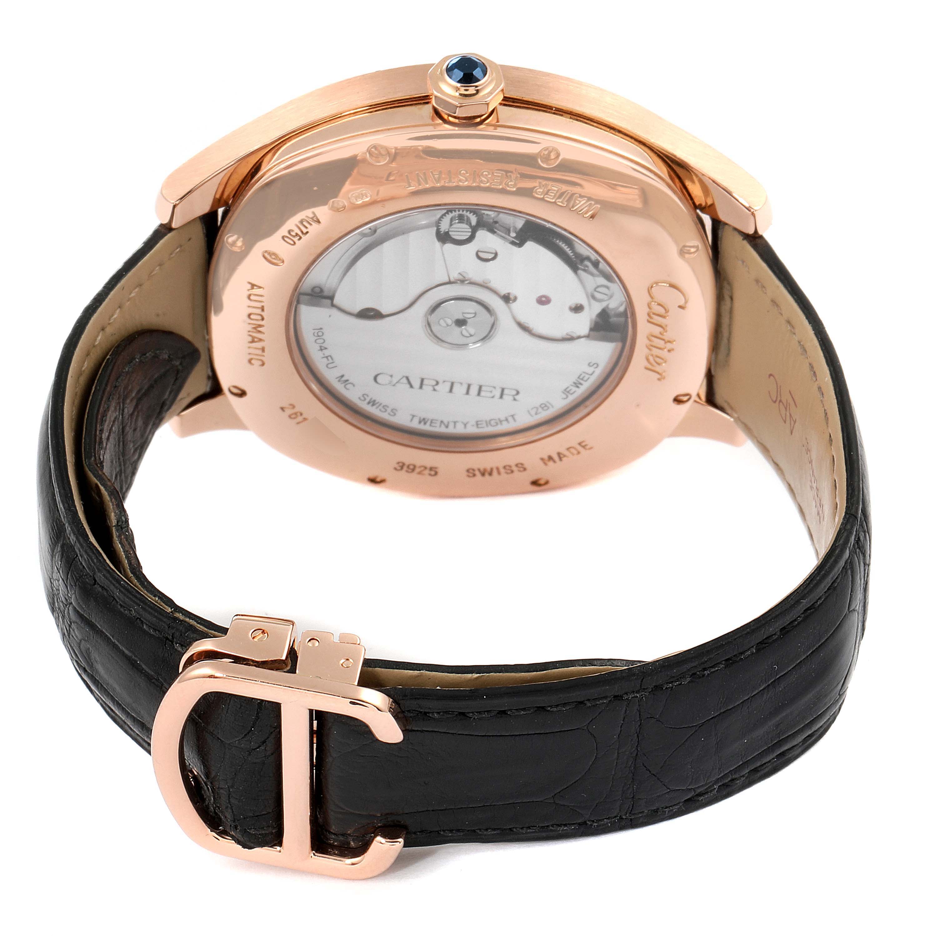 The image shows the back view of a Drive de Cartier watch, highlighting the case back, movement, crown with blue stone, and black leather strap with buckle.