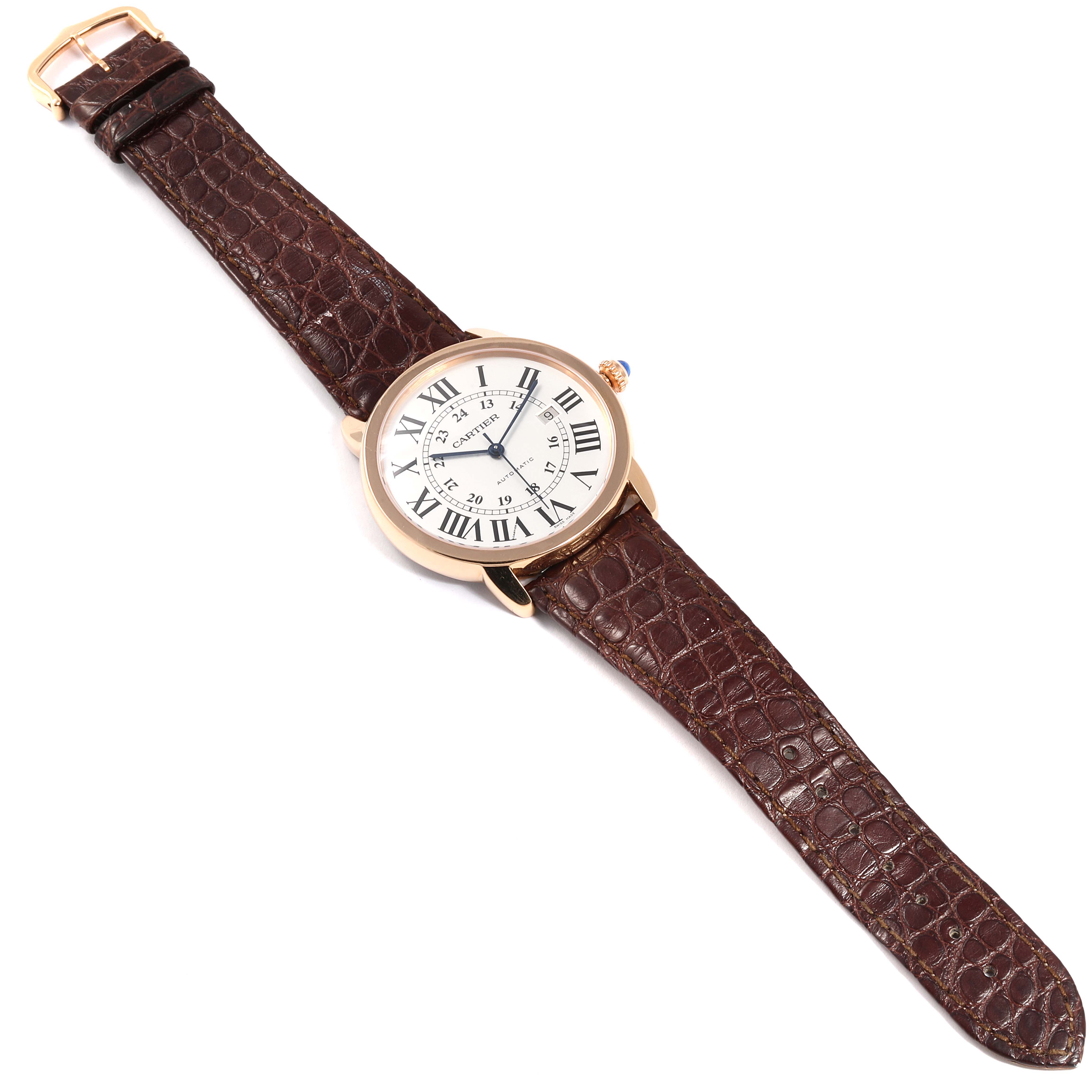 This image shows a Cartier Ronde W6701009 Men's Rose Gold Silver Dial W6701009 Men's Rose Gold Silver Dial model watch from a top-down angle, highlighting its face, case, and brown leather strap.