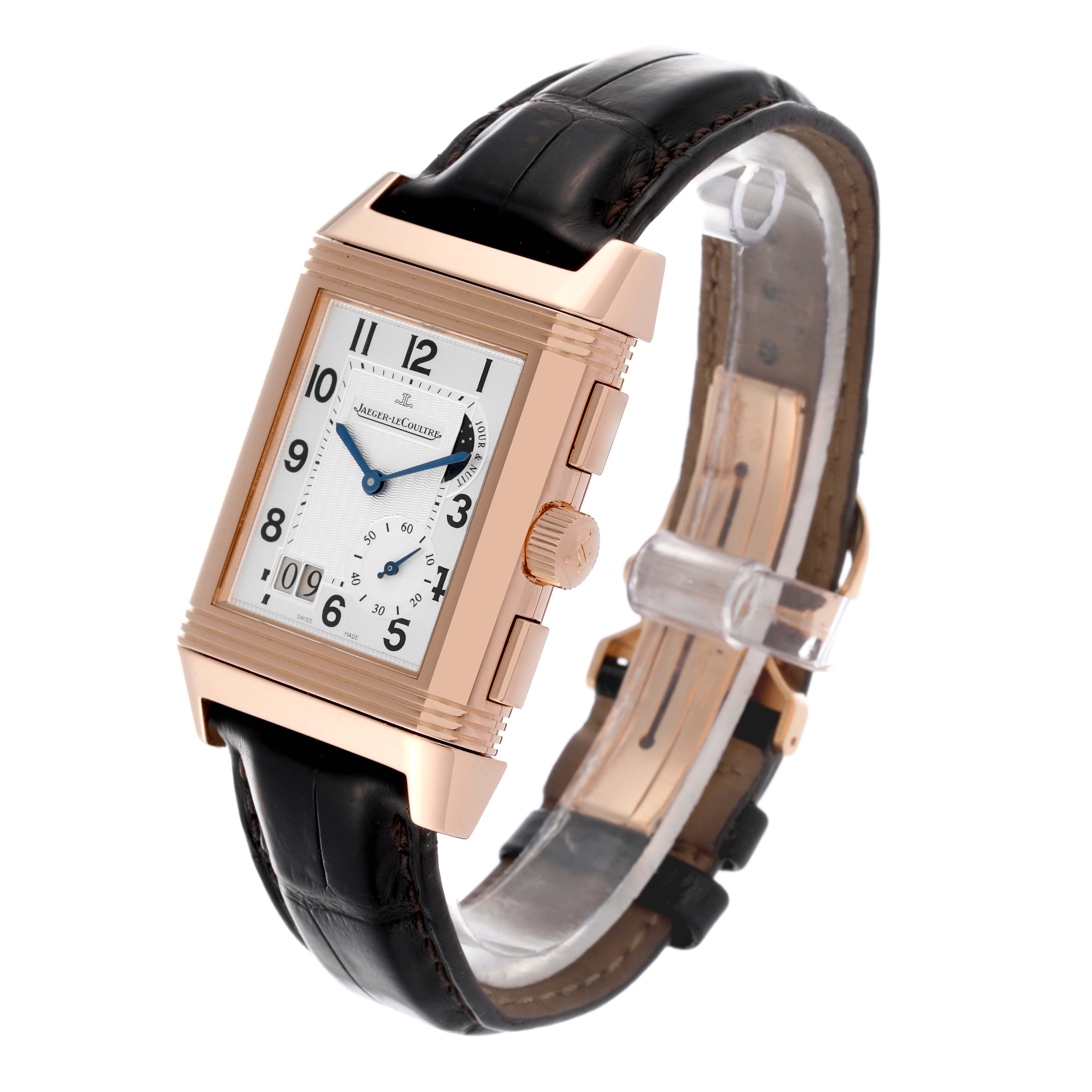The Jaeger-LeCoultre Reverso watch is shown at an angled side view, highlighting the rectangular case, crown, and leather strap.