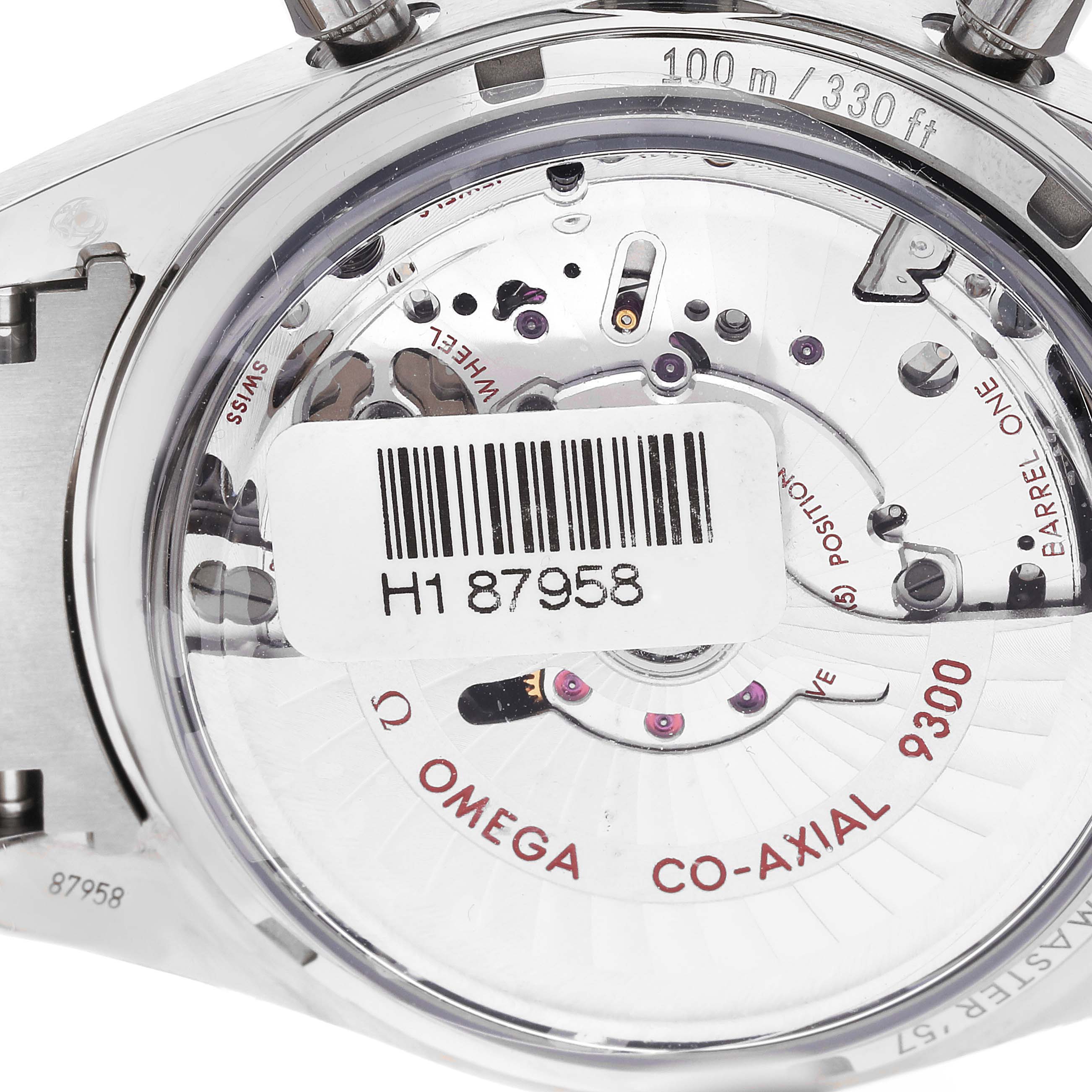 The image shows the backside of an Omega Speedmaster 331.90.42.51.04.001 Men's Titanium White Dial 331.90.42.51.04.001 Men's Titanium White Dial watch, focusing on the Co-Axial 9300 movement with a visible barcode label.
