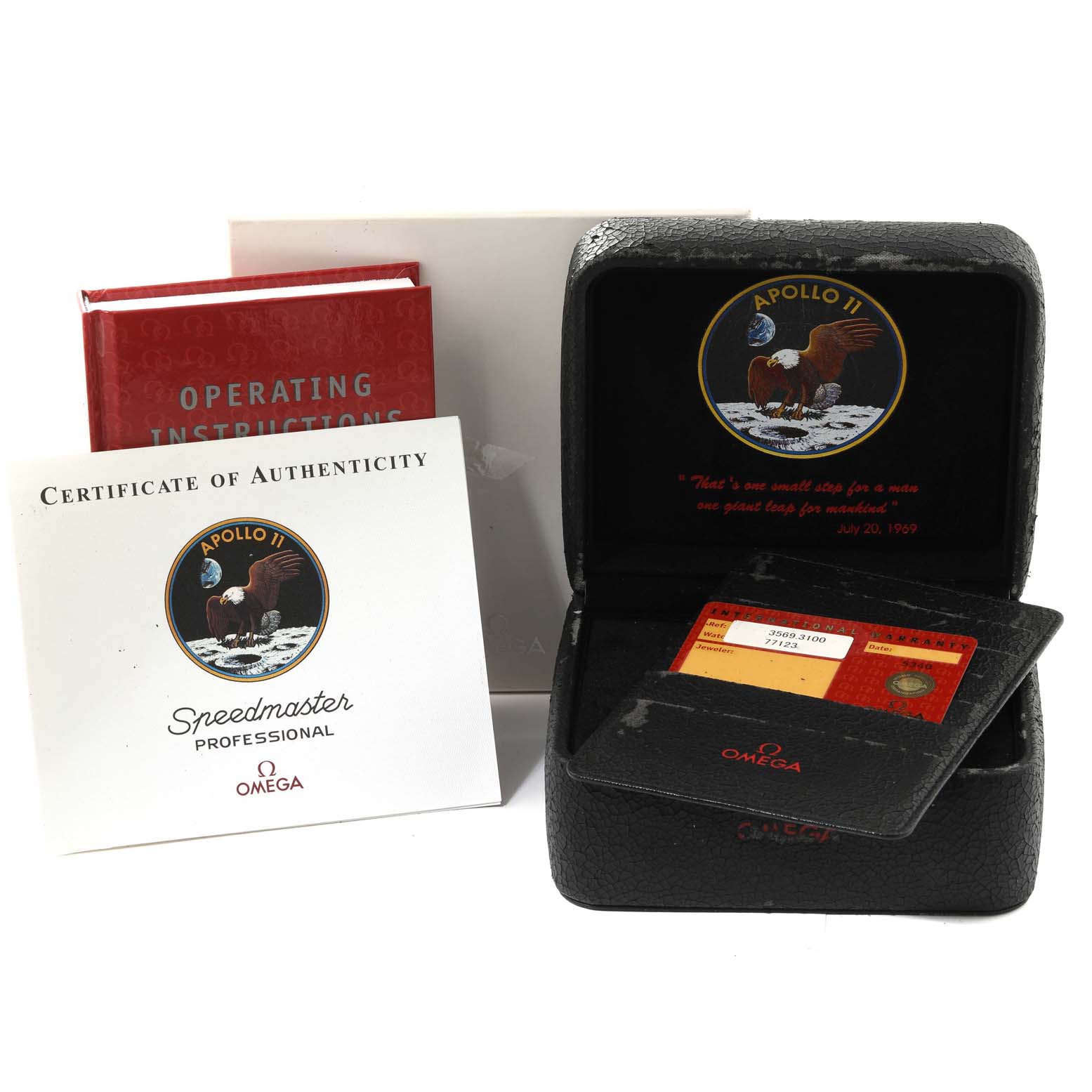 The image shows the accessories for an Omega Speedmaster 3569.31.00 Men
s Stainless Steel Silver Dial 3569.31.00 Men
s Stainless Steel Silver Dial model, including a certificate, operating instructions, and the watch box.