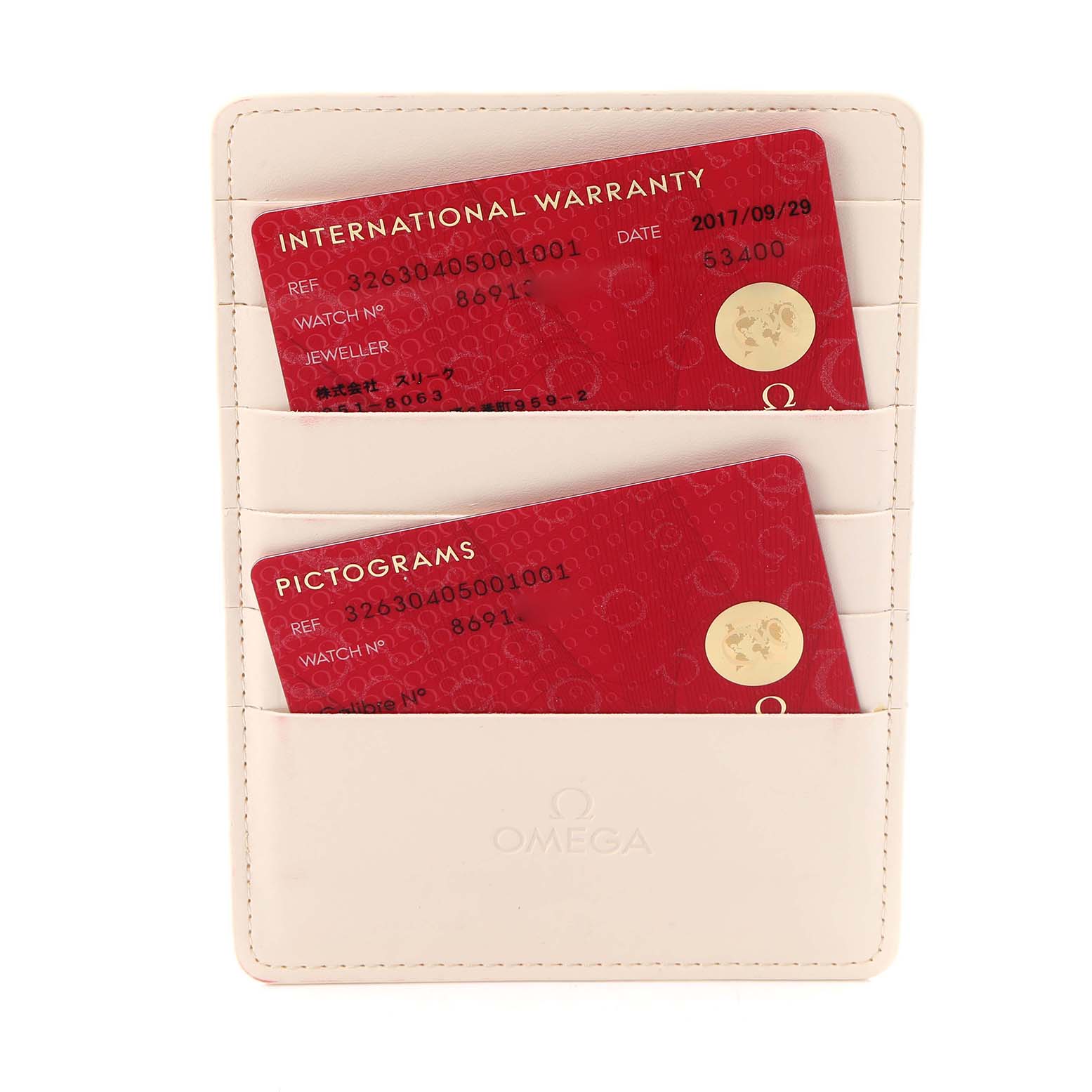 The image shows Omega Speedmaster model 326.30.40.50.01.001 accessories, specifically two red warranty and pictogram cards in a white cardholder.