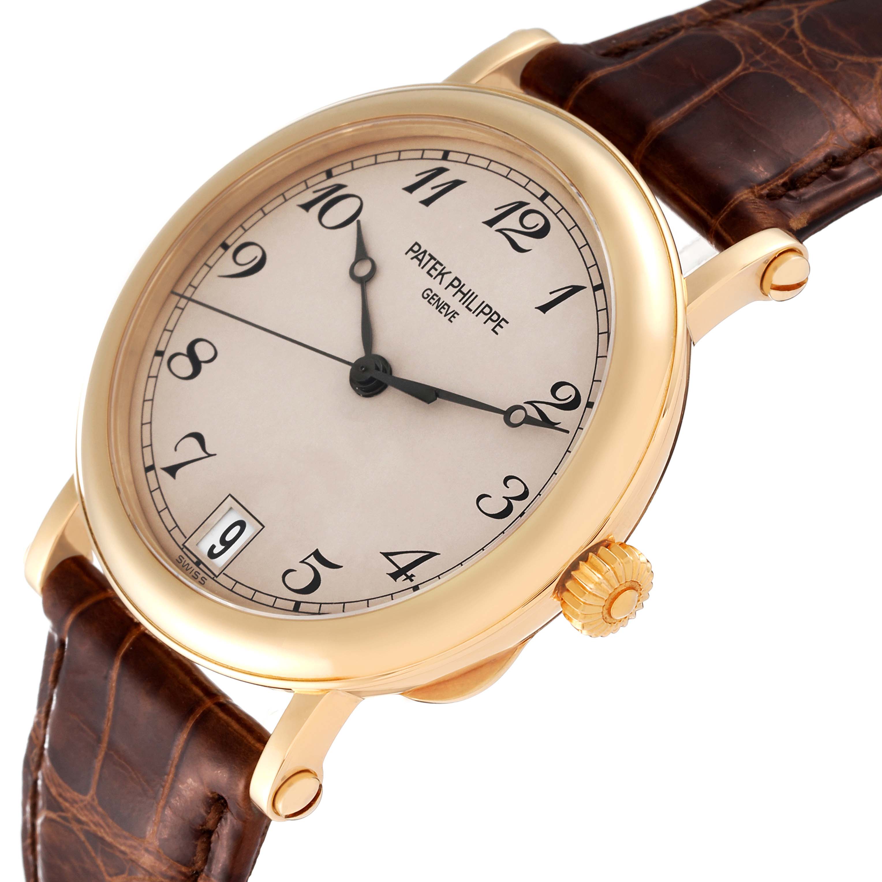 This image shows a Patek Philippe Calatrava 5053 Men's Yellow Gold Beige Dial 5053 Men's Yellow Gold Beige Dial watch at an angle highlighting its face, crown, and brown leather strap.
