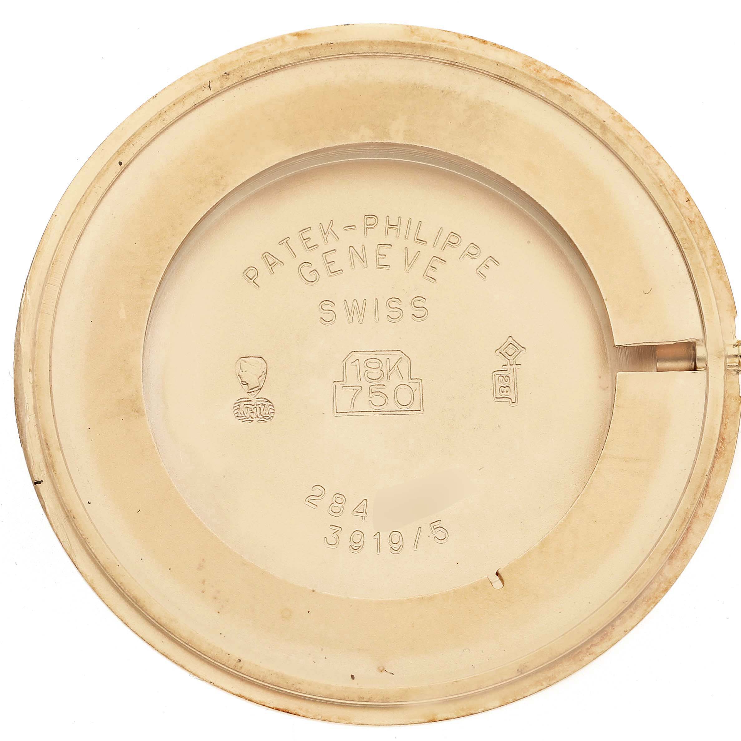 This image shows the inner caseback of a Patek Philippe Calatrava 3919/5 Men
s Yellow Gold White Dial 3919/5 Men
s Yellow Gold White Dial watch, highlighting markings and an 18K gold stamp.