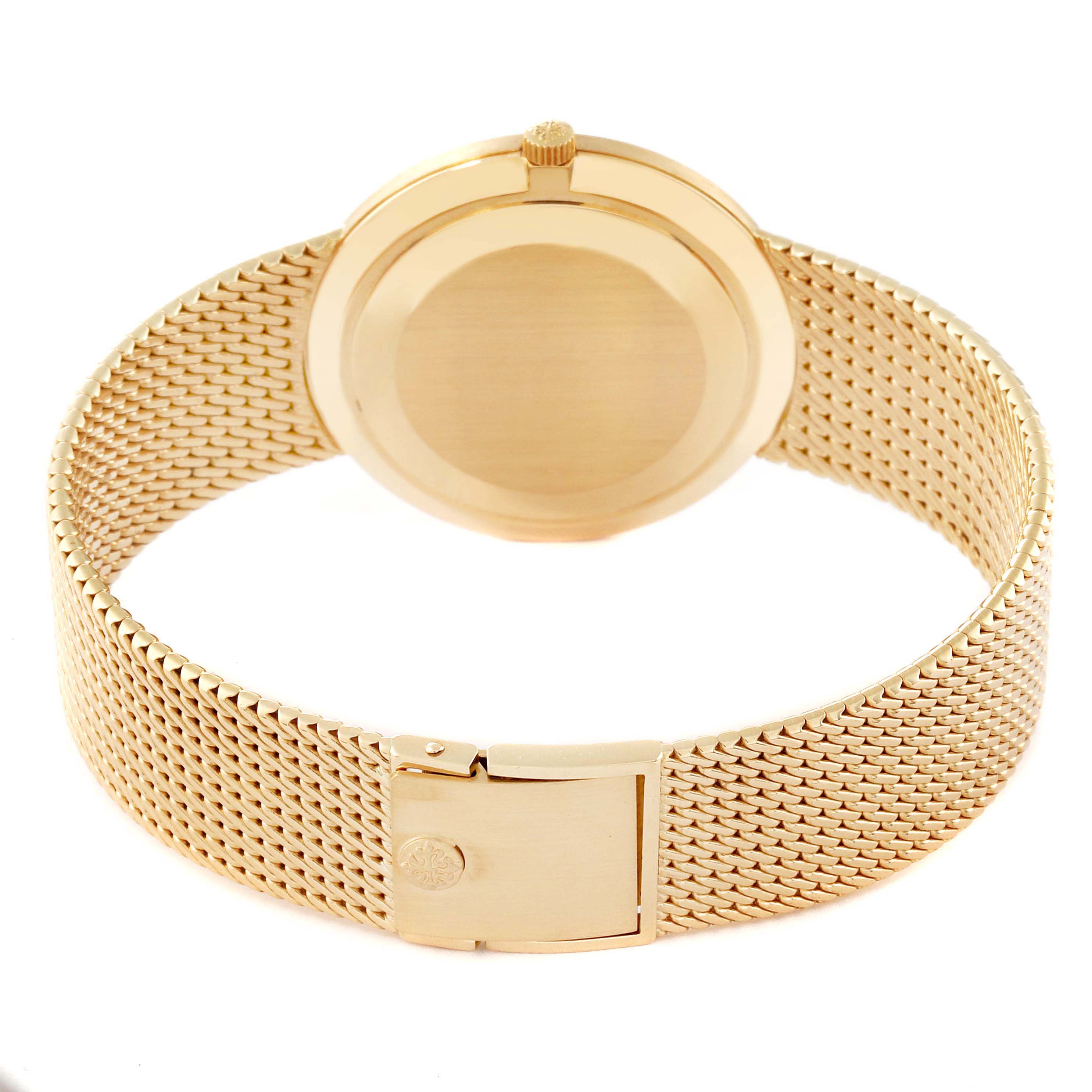 The image shows the back case, crown, and bracelet clasp of a Patek Philippe Calatrava 3919/5 Men
s Yellow Gold White Dial 3919/5 Men
s Yellow Gold White Dial watch.