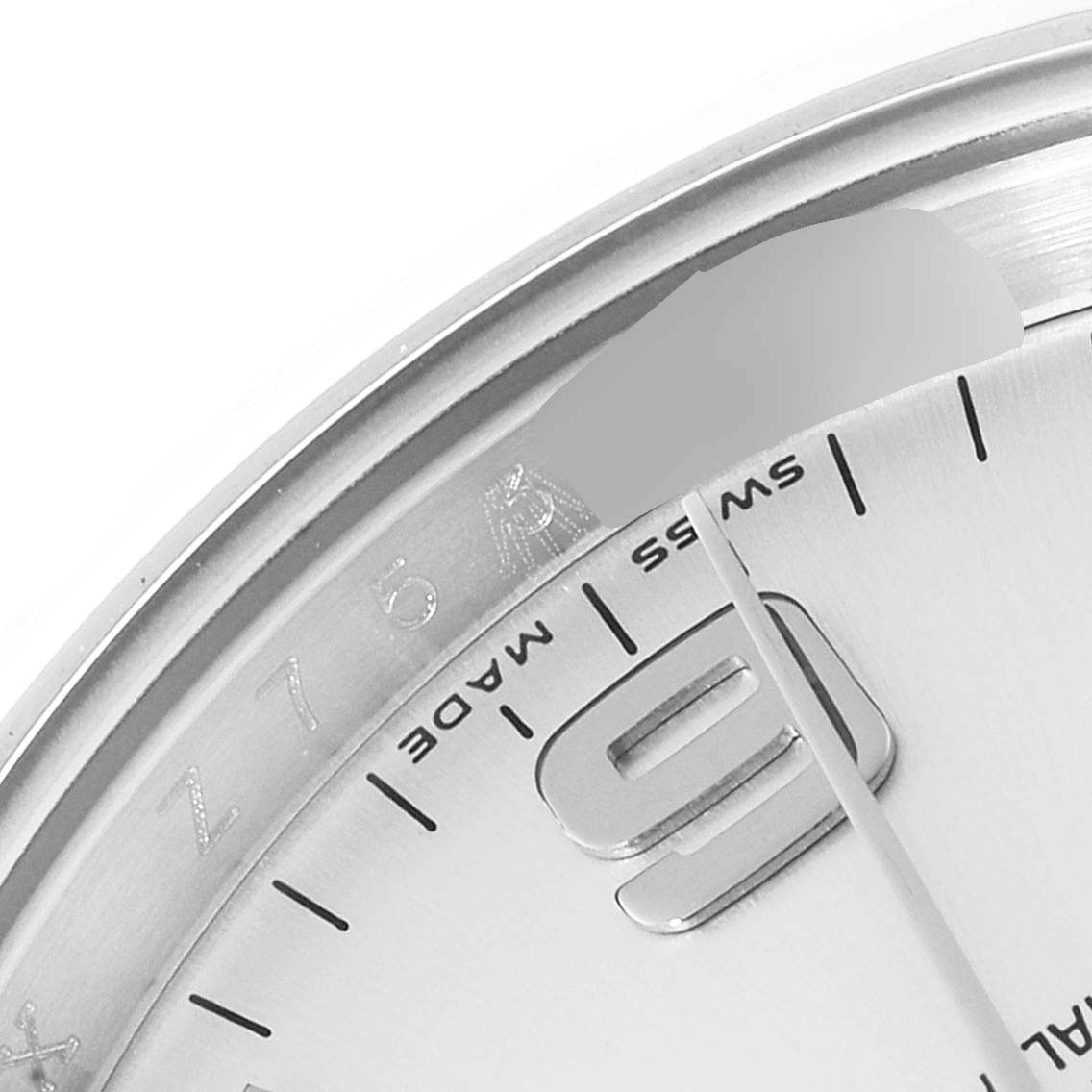 This close-up image of the Rolex Air-King 114200 Men's Stainless Steel Silver Dial 114200 Men's Stainless Steel Silver Dial watch shows part of the bezel, dial, and the number "9".