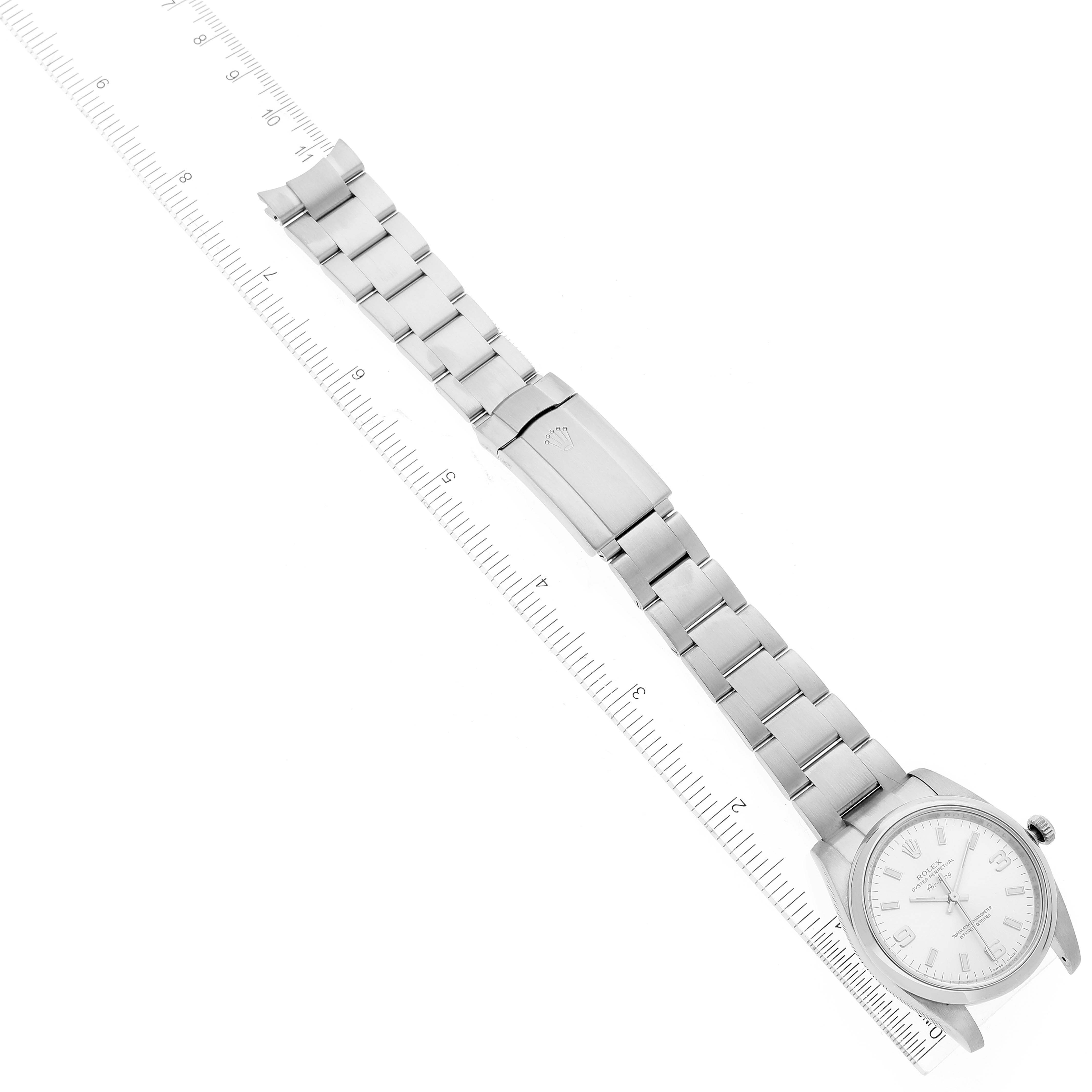 The image shows a Rolex Air-King 114200 Men's Stainless Steel Silver Dial 114200 Men's Stainless Steel Silver Dial watch laid flat, highlighting the watch face, bracelet, and clasp alongside a ruler for scale.