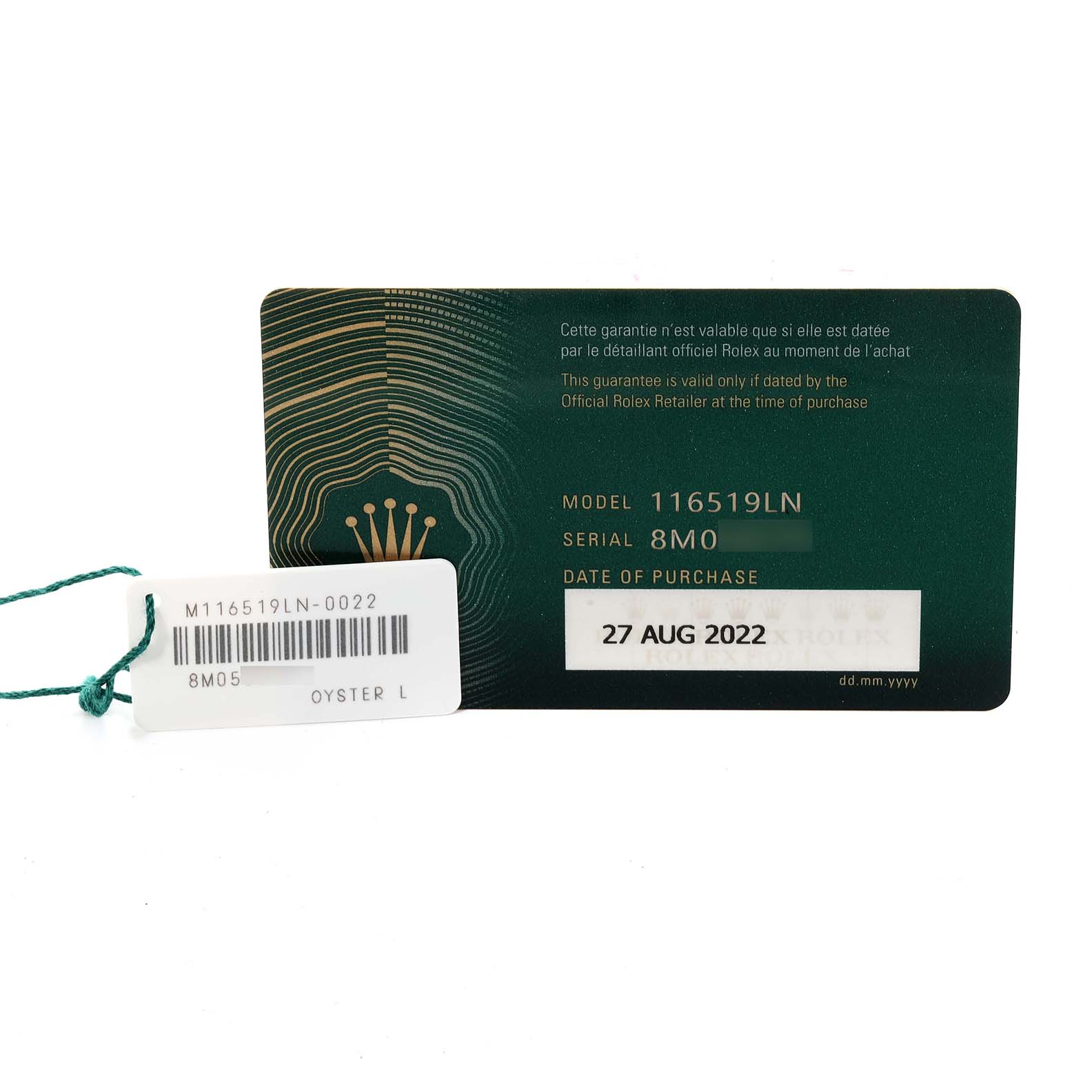 This image shows the warranty card and tag for a Rolex Daytona 116519 Men's White Gold Black Dial 116519 Men's White Gold Black Dial model 116519LN watch.