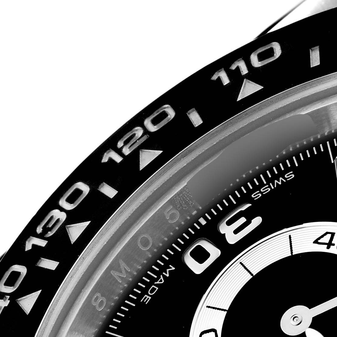 This image shows a close-up of the bezel and part of the dial of a Rolex Daytona 116519 Men's White Gold Black Dial 116519 Men's White Gold Black Dial watch.
