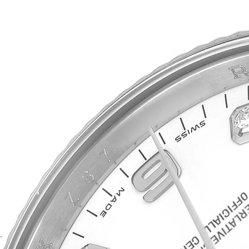 The image shows a close-up of the Rolex Datejust 115234 Men's Stainless Steel White Dial watch's dial, focusing on the bezel and hour markers.