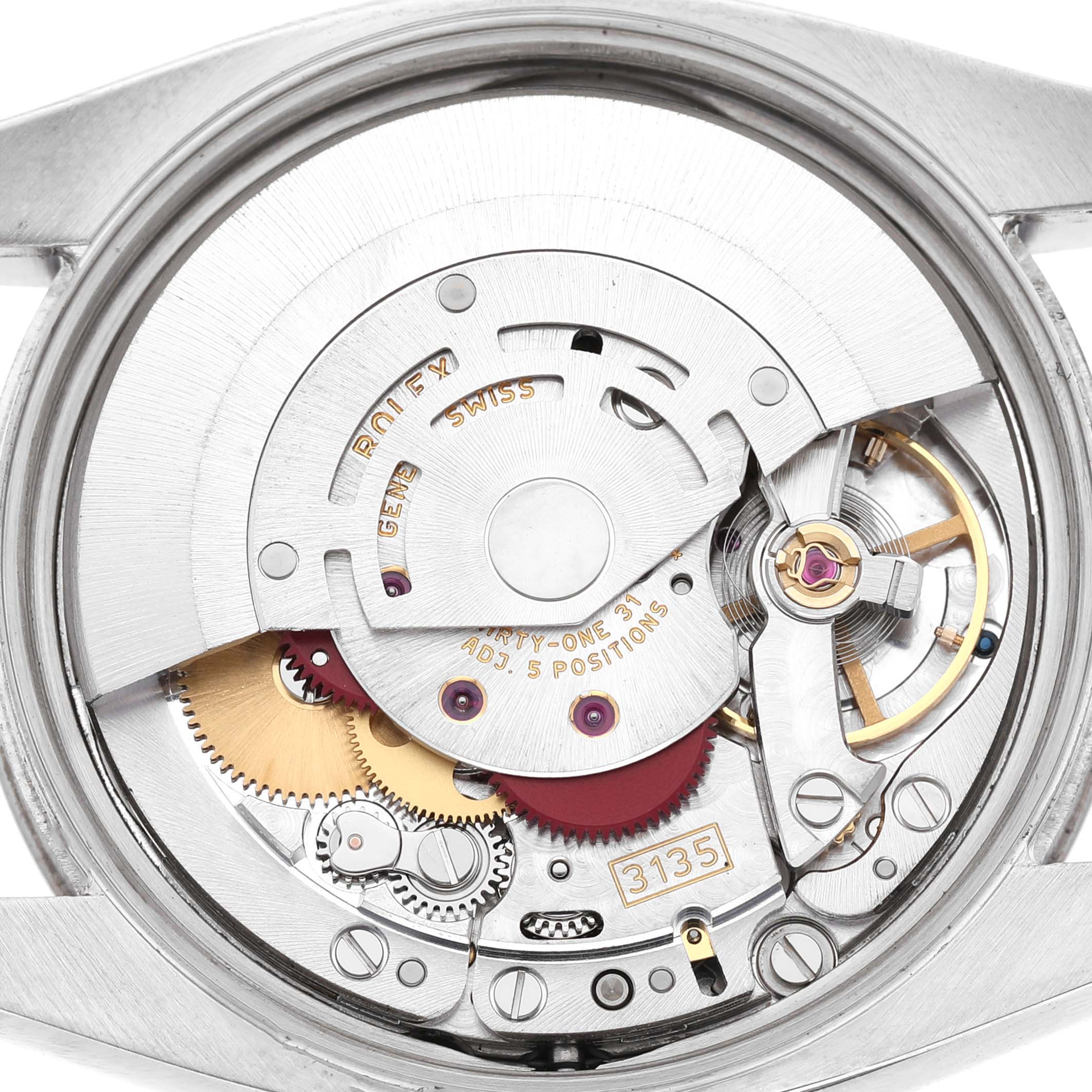 This image shows the movement of a Rolex Datejust 115234 Men's Stainless Steel White Dial, viewed from the back, showcasing its intricate mechanical parts.