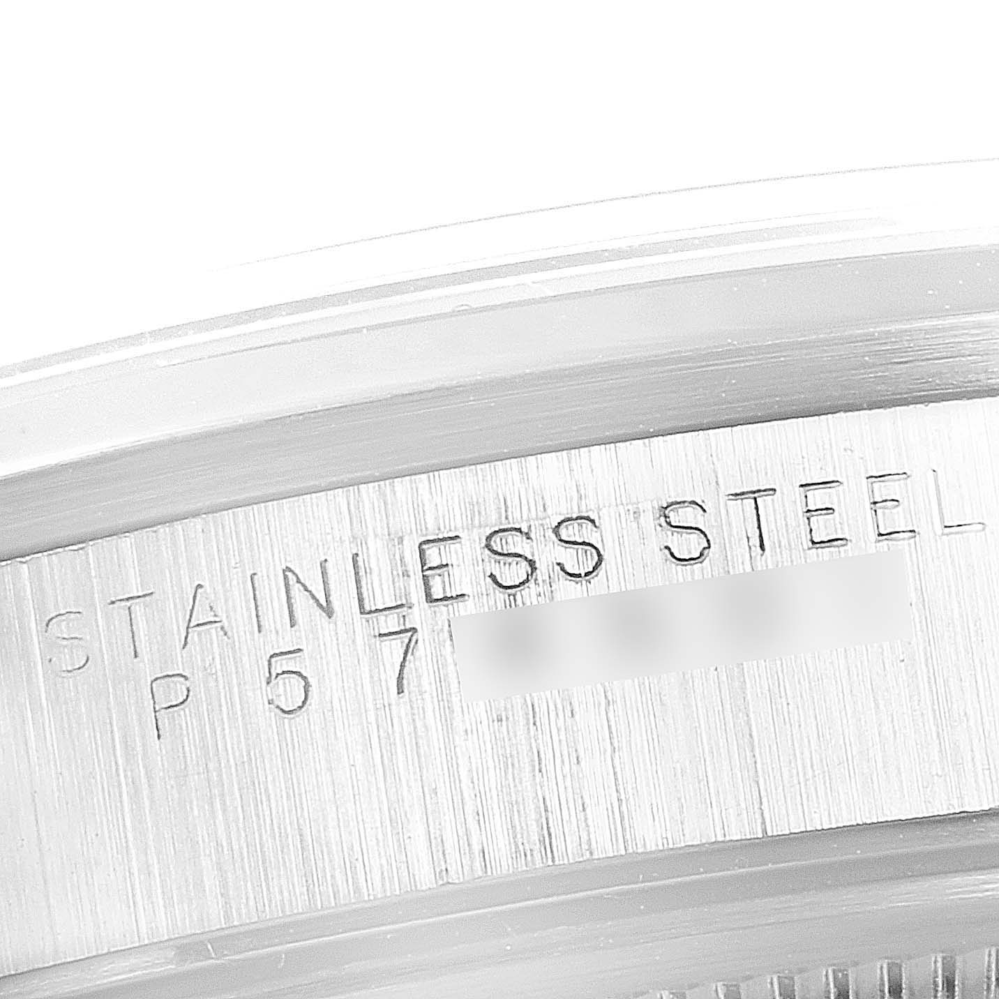This image shows a close-up of the serial engraving on the stainless steel case of a Rolex Date 15200 Men's Stainless Steel Black Dial 15200 Men's Stainless Steel Black Dial watch.