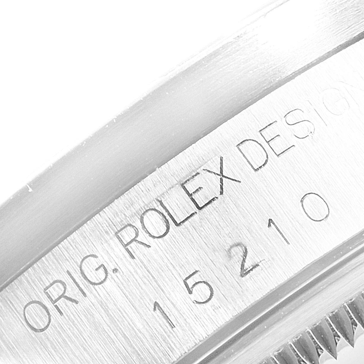 This image shows the edge of a Rolex Date 15210 Men's Stainless Steel Black Dial 15210 Men's Stainless Steel Black Dial model displaying the engraving with the model number and "ORIG. ROLEX DESIGN".