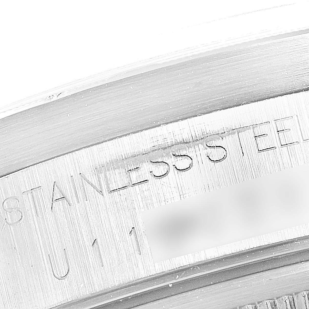 This image shows a close-up view of the stainless steel case back engraving of a Rolex Date 15210 Men's Stainless Steel Black Dial 15210 Men's Stainless Steel Black Dial model watch.