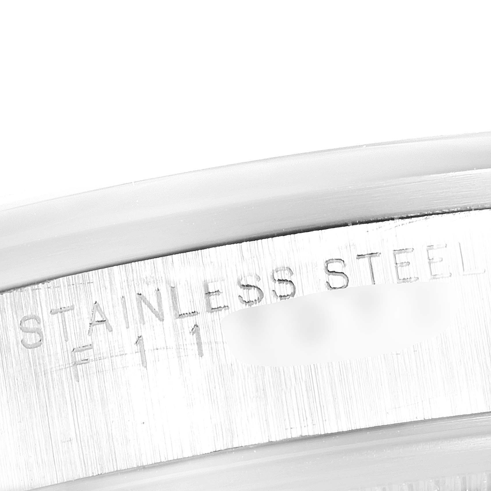 The image shows a close-up of the text "STAINLESS STEEL" on the case of a Rolex Date 15200 Men's Stainless Steel Silver Dial 15200 Men's Stainless Steel Silver Dial model watch.
