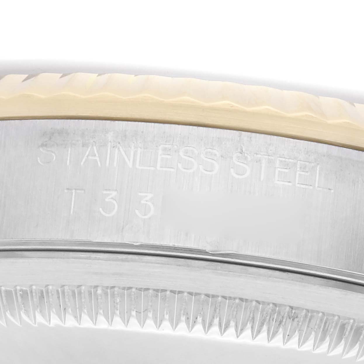 The image shows a close-up of the side view of a Rolex Datejust model 16233, highlighting the stainless steel bezel and fine detail of the edge.