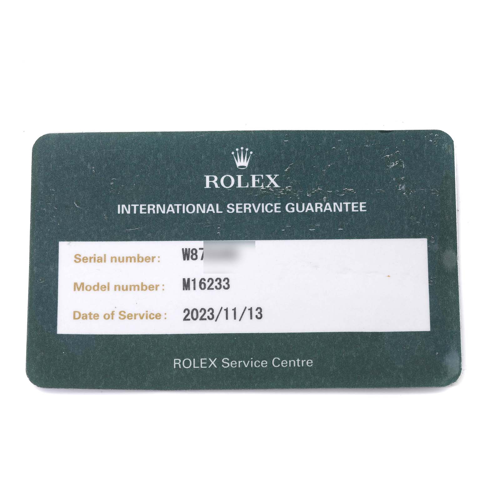 This image shows a Rolex Datejust 16233 Men's Steel and Gold (two tone) Champagne Dial 16233 Men's Steel and Gold (two tone) Champagne Dial model M16233 International Service Guarantee card displaying serial and model numbers.