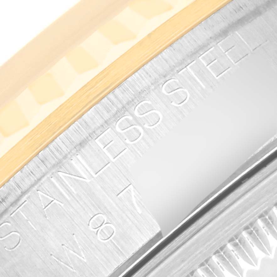 This close-up image shows a portion of the bezel and the etched "STAINLESS STEEL" text on the Rolex Datejust 16233 Men's Steel and Gold (two tone) Champagne Dial 16233 Men's Steel and Gold (two tone) Champagne Dial watch.