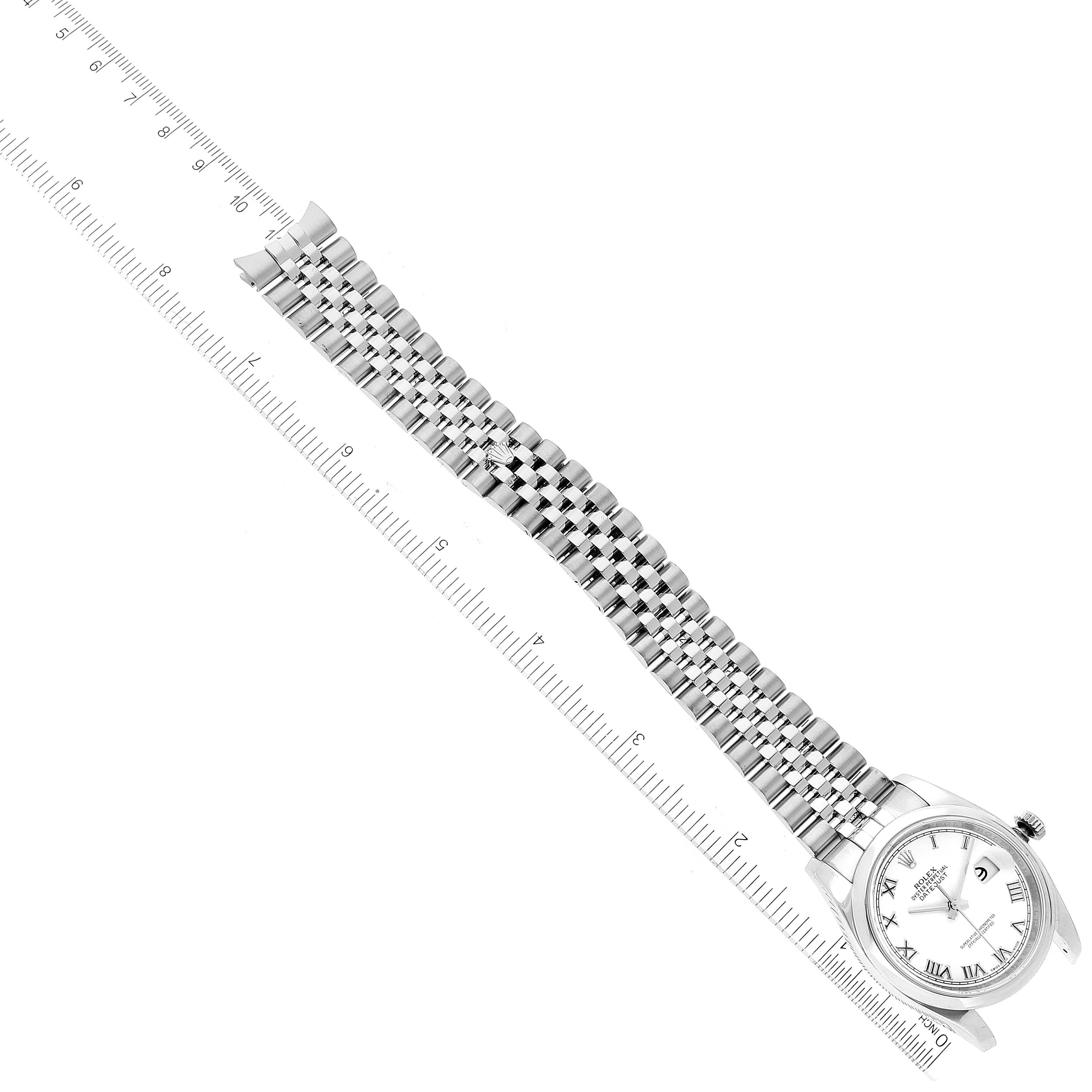The image shows a top-down view of a Rolex Datejust 116200 Men's Stainless Steel White Dial 116200 Men's Stainless Steel White Dial watch with a stainless steel band next to a ruler.