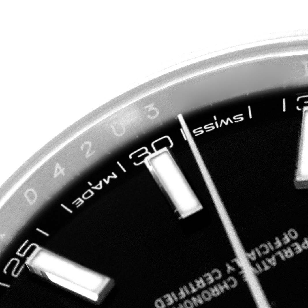 The image shows a close-up of the dial of a Rolex Datejust model 126300, highlighting the Swiss Made text, hour markers, and part of the minute hand.