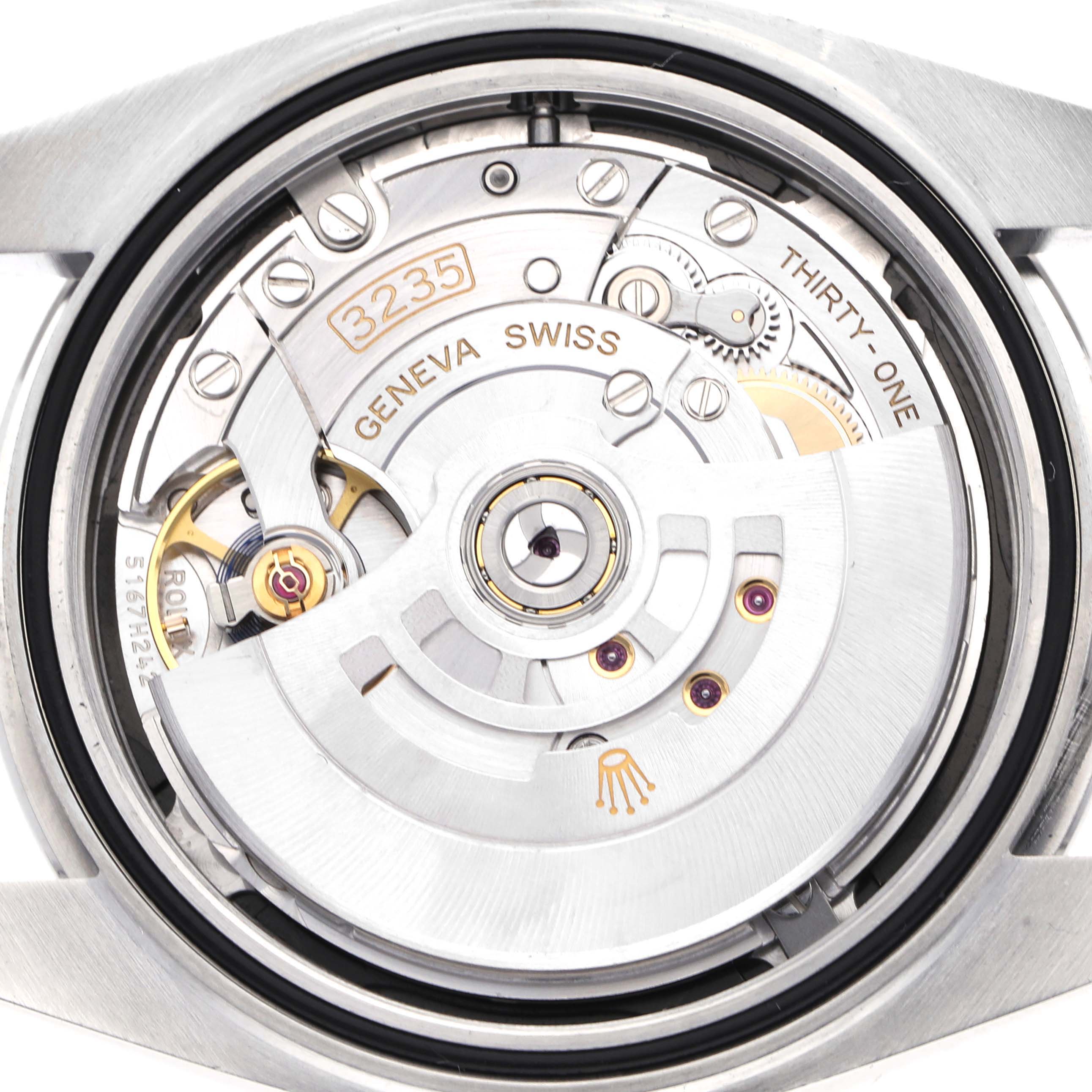 The image shows a close-up of the Rolex Datejust model 126300, revealing its movement and internal mechanism from a rear angle.