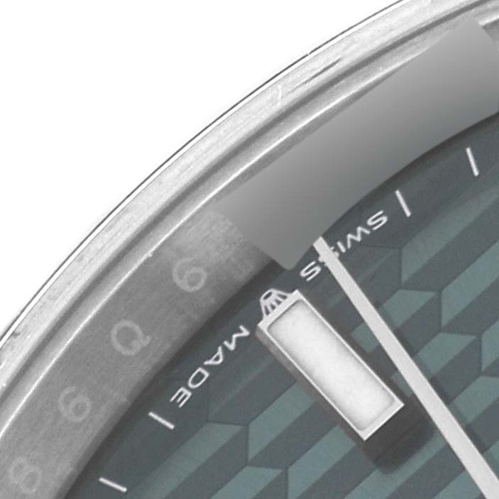 The image shows a close-up of a portion of the dial and bezel of the Rolex Datejust 41 126300 Men's Stainless Steel Green Dial 126300 Men's Stainless Steel Green Dial watch.