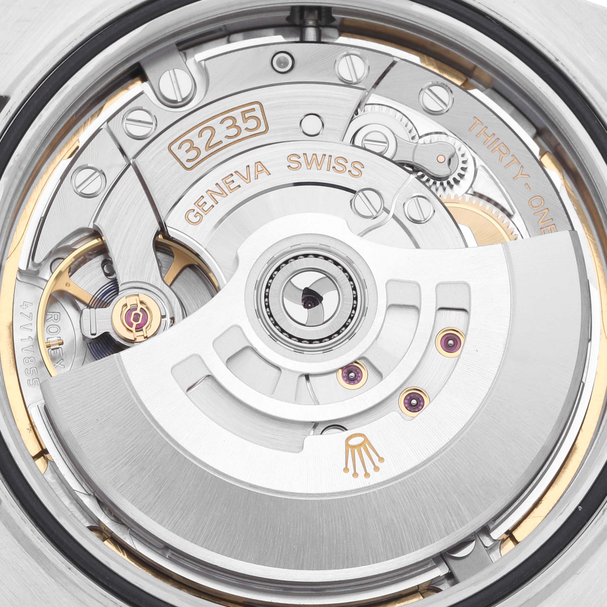 The image shows the rotor and movement of a Rolex Datejust 41 126334 Men
s Stainless Steel Blue Dial 126334 Men
s Stainless Steel Blue Dial from the back, highlighting the Geneva Swiss inscription and intricate mechanisms.