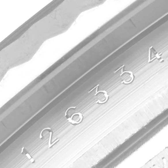 The image shows a close-up of the fluted bezel and part of the dial markers on a Rolex Datejust 41 126334 Men
s Stainless Steel Blue Dial 126334 Men
s Stainless Steel Blue Dial watch.