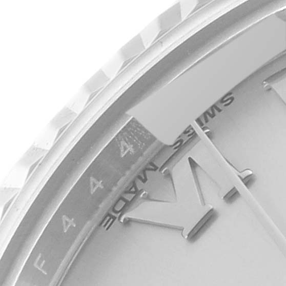 This close-up of a Rolex Mid-Size 178274 Women
s Stainless Steel Silver Dial 178274 Women
s Stainless Steel Silver Dial model shows part of the bezel, dial, and a segment of the Roman numeral "VI."