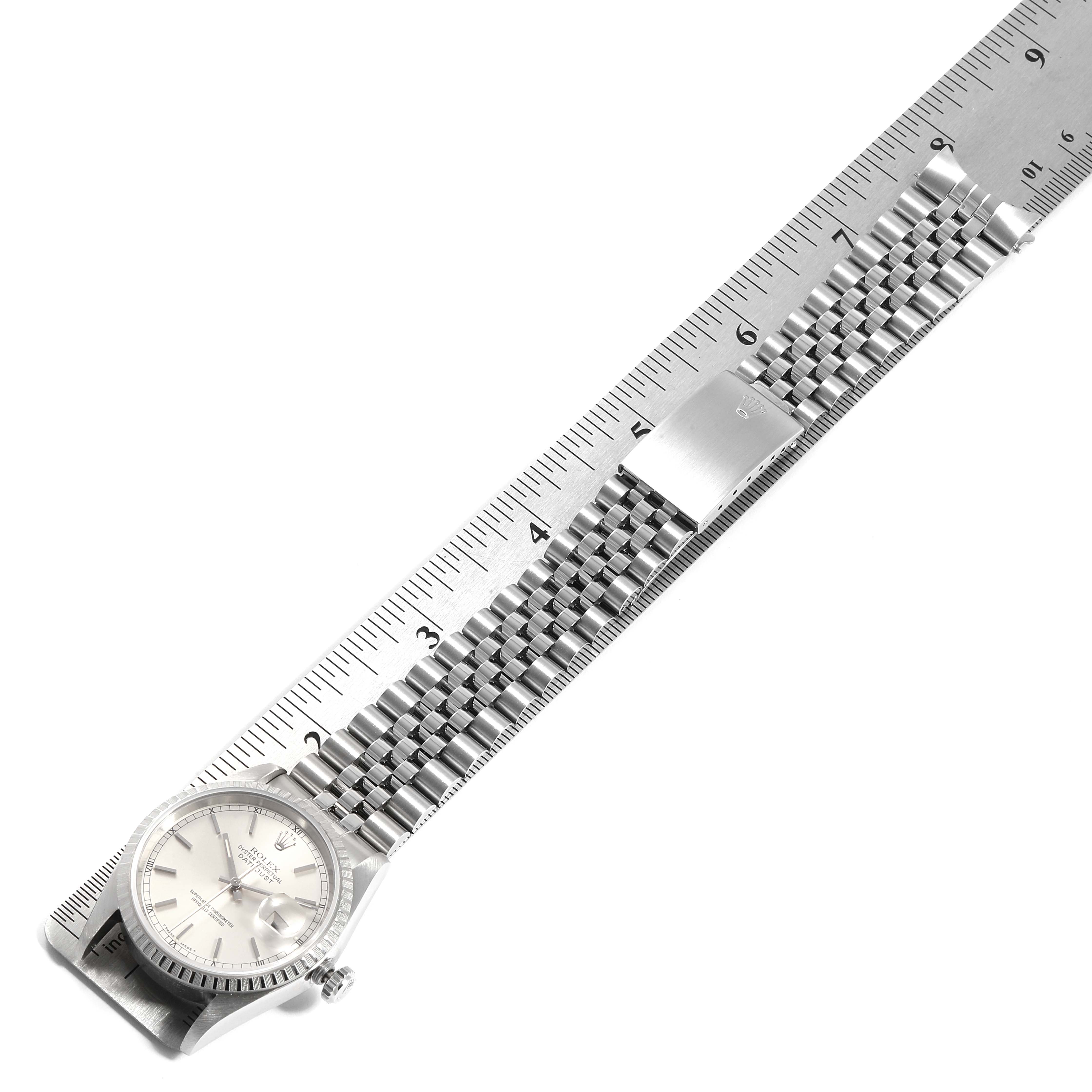 The image shows a Rolex Datejust 16220 Men's Stainless Steel Silver Dial 16220 Men's Stainless Steel Silver Dial watch laid flat with its face and bracelet visible, aligned next to a ruler for measurement.