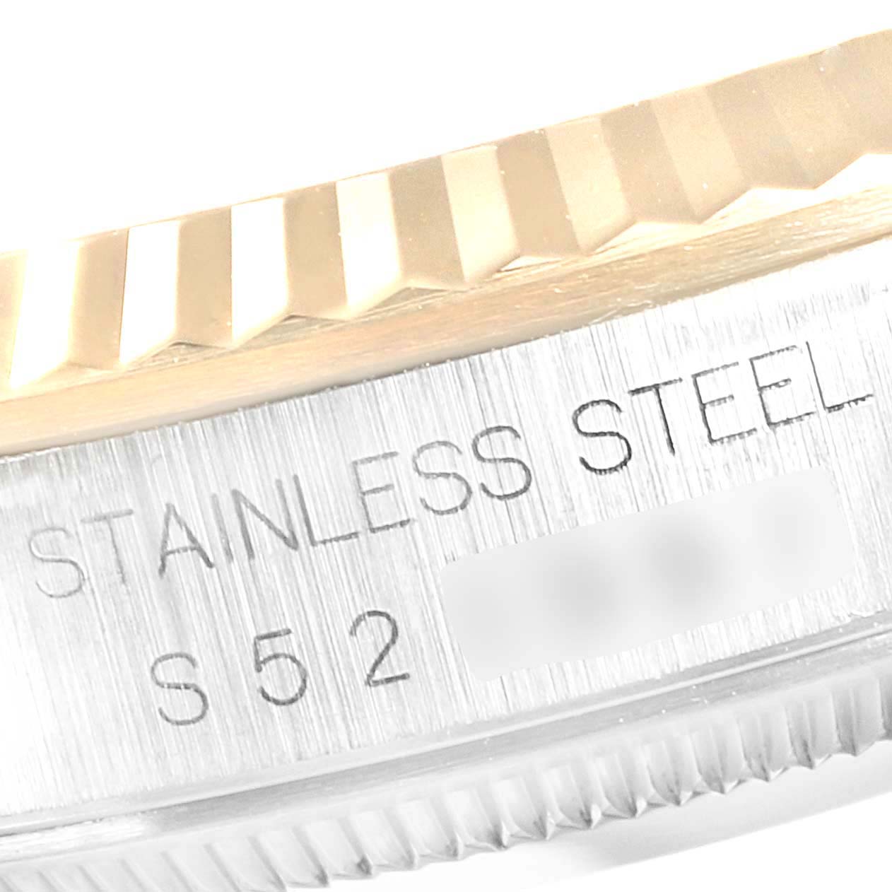 The image shows a close-up of the fluted bezel and outer edge engraving on a Rolex Datejust 16233 Men
s Steel and Gold (two tone) Champagne Dial 16233 Men
s Steel and Gold (two tone) Champagne Dial watch.