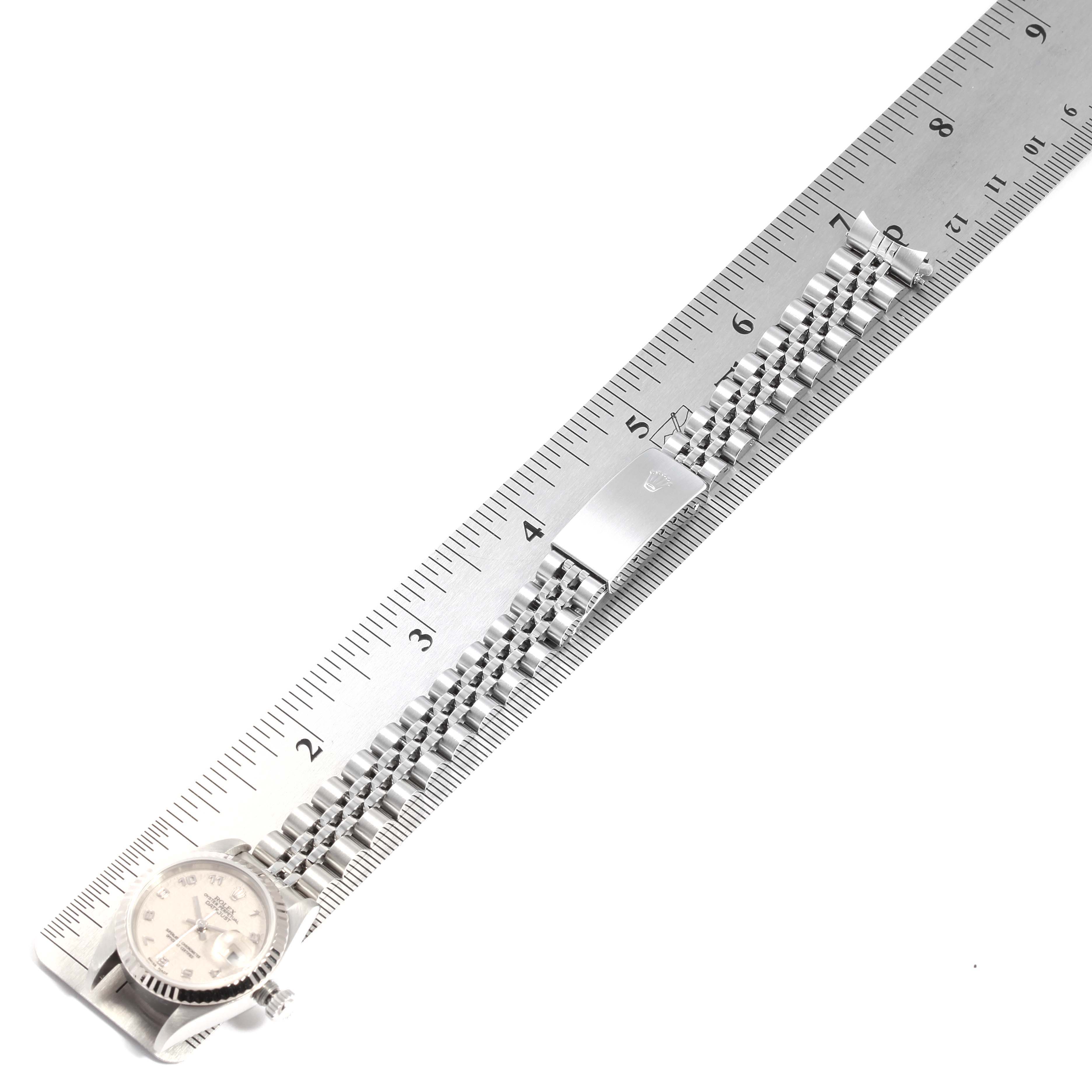 The Rolex Datejust 79174 Women
s Stainless Steel Silver Dial 79174 Women
s Stainless Steel Silver Dial watch is shown from an overhead angle, displaying its face, bezel, and metal bracelet.