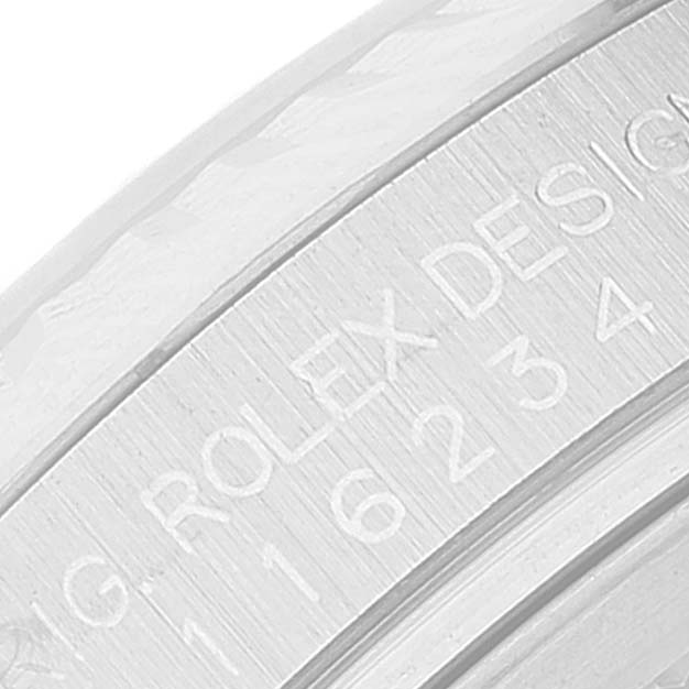 This close-up image shows the engraved inscription on the case of a Rolex Datejust 116234 Men's Stainless Steel Silver Dial 116234 Men's Stainless Steel Silver Dial watch.