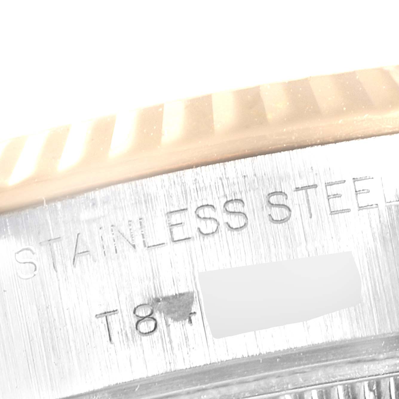 This close-up image shows the side engraving on a Rolex Datejust 69173 Women
s Steel and Gold (two tone) Black Dial 69173 Women
s Steel and Gold (two tone) Black Dial model, including "STAINLESS STEEL".