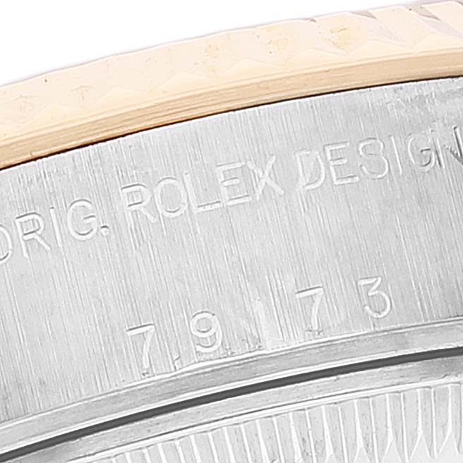 This image shows a close-up of the Rolex Datejust 79173 Women
s Steel and Gold (two tone) Blue Dial 79173 Women
s Steel and Gold (two tone) Blue Dial watch
s case side with engraved numbers and text.