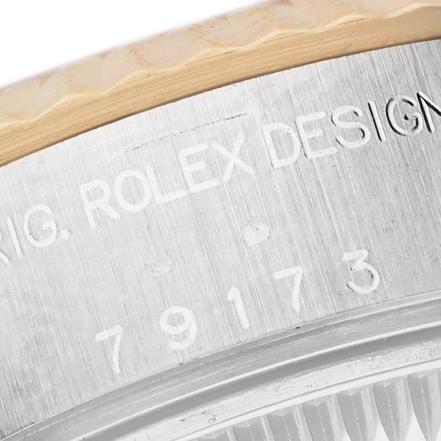 The image shows a close-up of the Rolex Datejust 79173 Women's Steel and Gold (two tone) Champagne Dial 79173 Women's Steel and Gold (two tone) Champagne Dial's bezel and case, highlighting the engraving on the case edge.