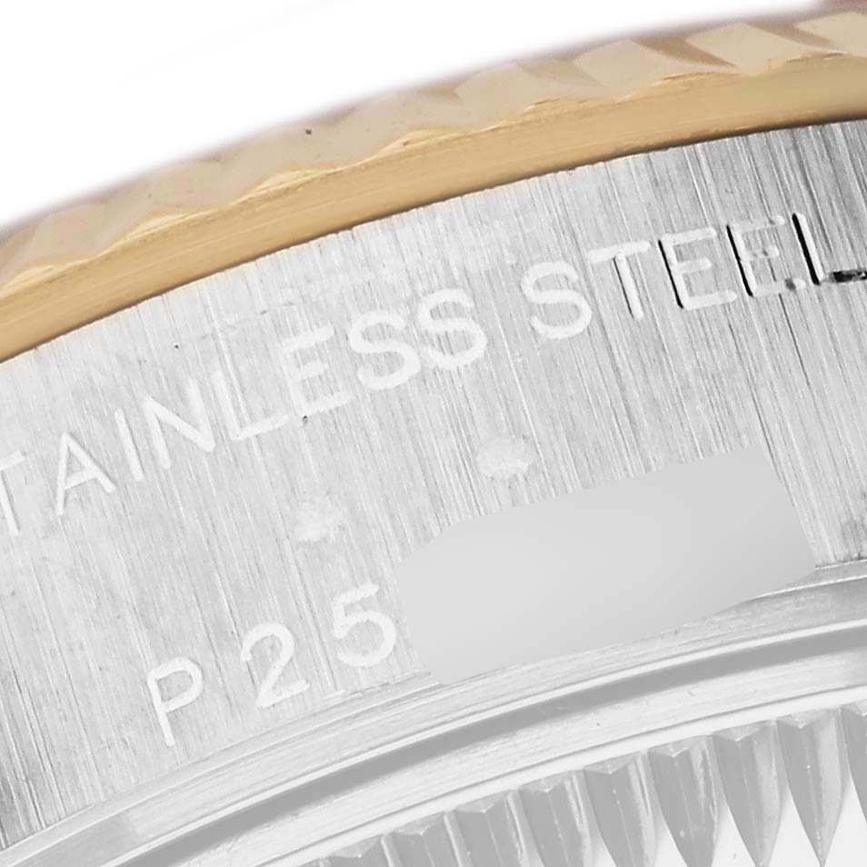 This close-up image of the Rolex Datejust 79173 Women's Steel and Gold (two tone) Champagne Dial 79173 Women's Steel and Gold (two tone) Champagne Dial watch shows the stainless steel part with engraved text.
