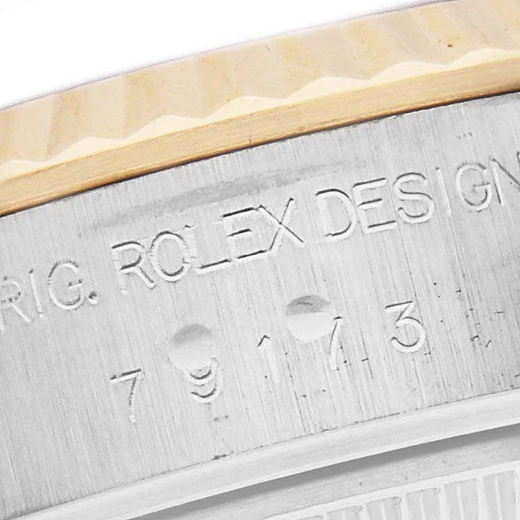 The image shows a close-up of the side of a Rolex Datejust, model 79173, focusing on the engraved model number and part of the fluted bezel.