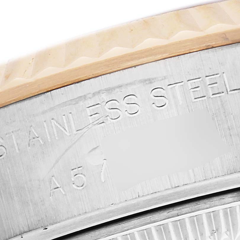 The image shows a close-up of the edge of a Rolex Datejust model 79173 with visible engraving on the stainless steel part.