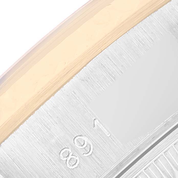 The image shows a close-up of the bezel and part of the caseback of a Rolex Datejust 69173 Women's Steel and Gold (two tone) Champagne Dial 69173 Women's Steel and Gold (two tone) Champagne Dial watch.