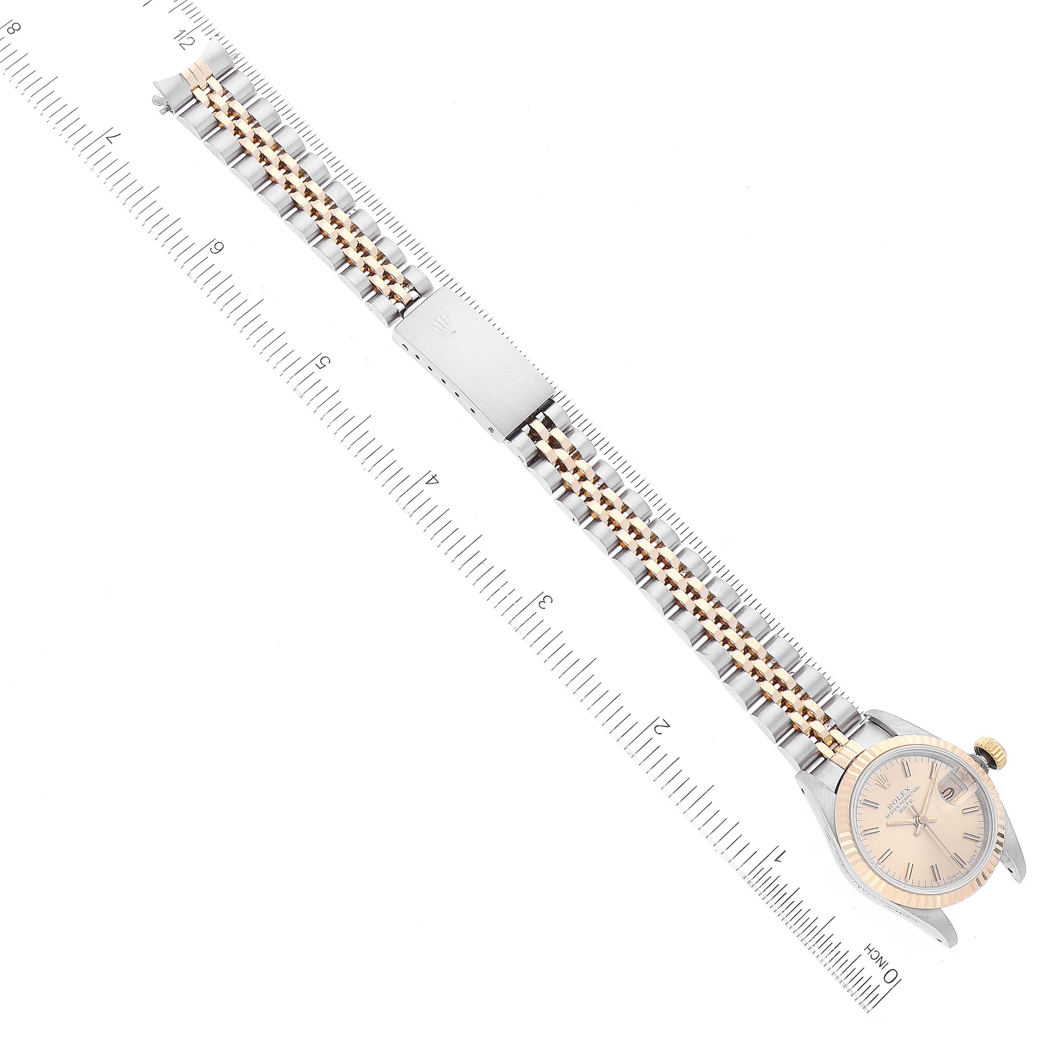 The image shows a Rolex Datejust 69173 Women's Steel and Gold (two tone) Champagne Dial 69173 Women's Steel and Gold (two tone) Champagne Dial watch from a top view, highlighting the face, bezel, and bracelet against a ruler for scale.